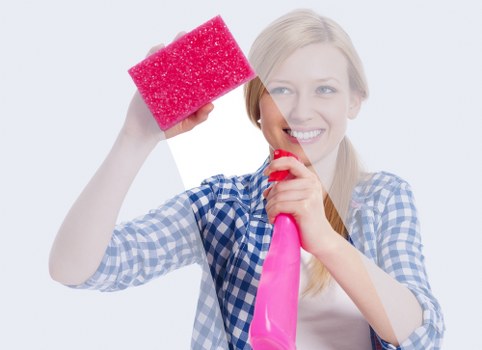 Deep cleaning a fabric couch with upholstery equipment